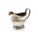 A George III silver cream jug, by Jonathan Hayne, London 1826, oval form, leaf capped scroll handle,