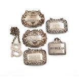 A collection of silver wine labels, comprising: a pair of rectangular form, foliate borders, maker's