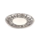 A French silver dish, circular form, pierced and chased with foliate scroll decoration and with four