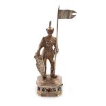 A German silver-gilt model of a knight, modelled in a standing position holding a lance and