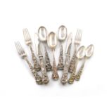 A collection of Victorian silver and silver-gilt Bacchanalian pattern flatware, by George Adams,