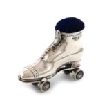 An Edwardian novelty silver roller skate pin cushion, by Serle and Co., Birmingham 1909, length