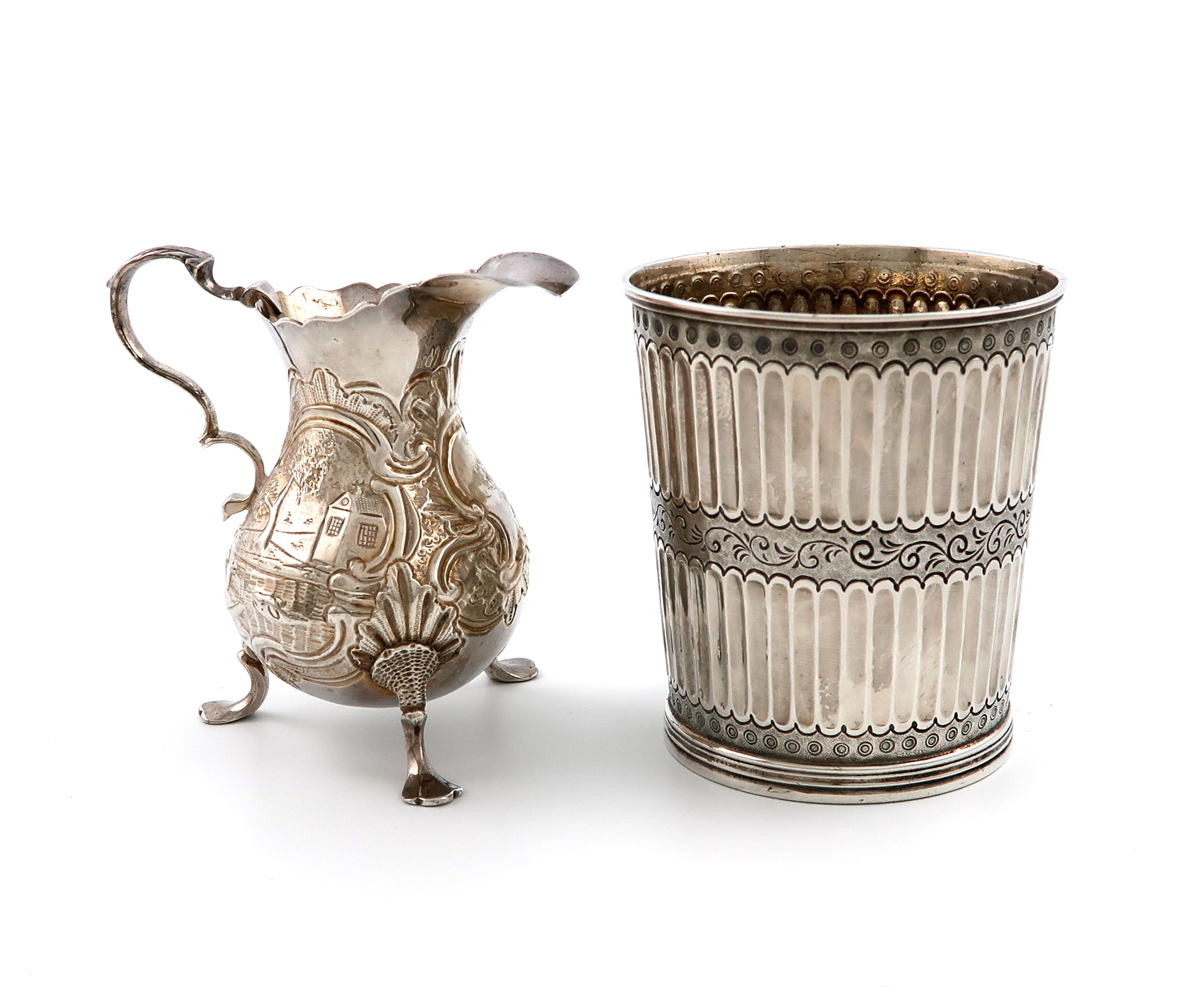 A George II silver cream jug, maker's mark W?, London 1744, baluster form, embossed with animals and