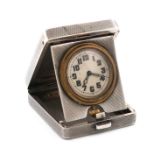 A silver travelling time-piece, by A. Wilcox, Birmingham 1932, rectangular form, hinged cover,