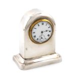 A silver clock, by James Deakin and Sons, Chester 1913, plain arched form, on a shaped rectangular