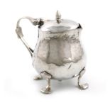 By Liberty and Co, a late-Victorian silver mustard pot, Birmingham 1900, baluster form, embossed