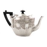 A late-Victorian silver teapot, by James Dixon and Sons, Sheffield 1895, shaped oval form, chased