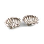 By F. Courthope, a pair of Edwardian Arts and Crafts silver shell butter dishes, London 1901,