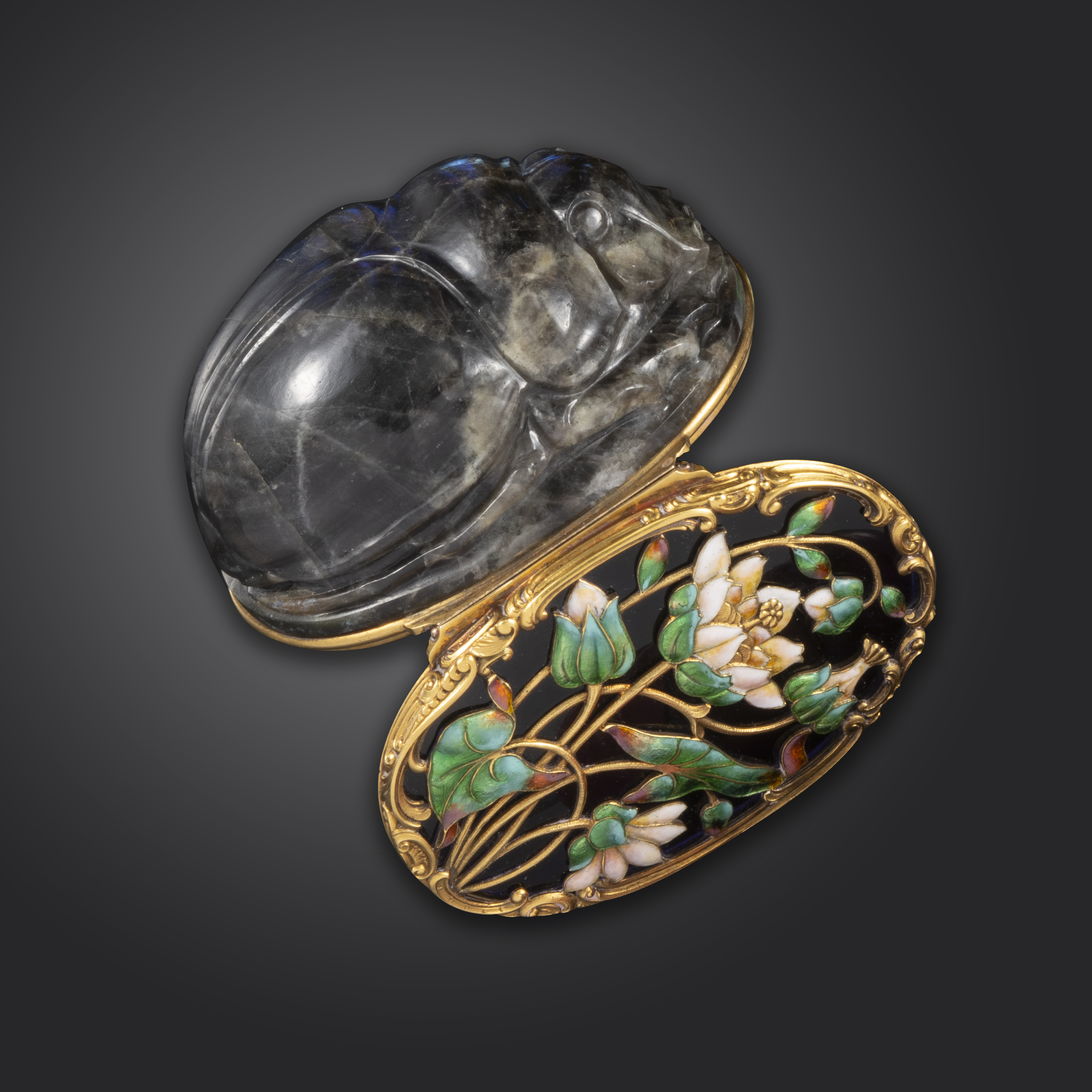 A mid 18th century carved labradorite scarab-form snuff box, the hinged blue glass cover decorated