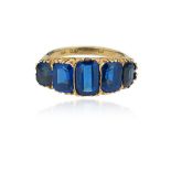 A synthetic sapphire half-hoop ring, set with graduated rectangular-cut synthetic sapphires in