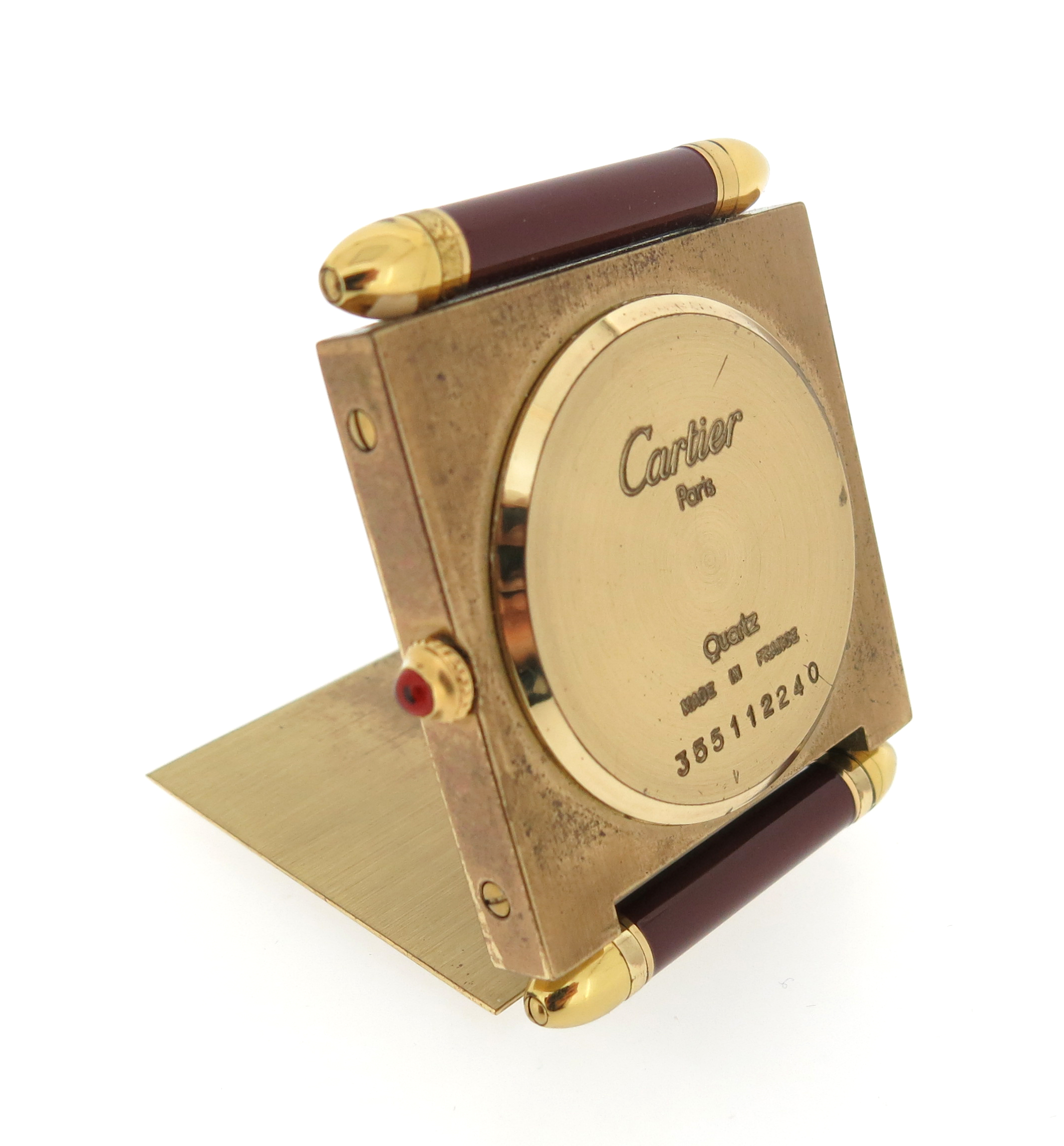 Three travel clocks by Cartier, including a Must de Cartier brass and red enamel travel alarm clock, - Image 7 of 9