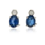 A pair of sapphire and diamond earrings, the round brilliant-cut diamonds suspend oval-shaped