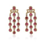 A pair of ruby and diamond-set gold drop earrings, with bow-form upper sections, each suspending