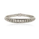 A diamond line bracelet, set with round brilliant-cut diamonds in an openwork diagonal-link border