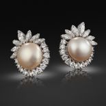 A pair of natural pearl and diamond cluster earrings, the button-shaped pearls are set within a