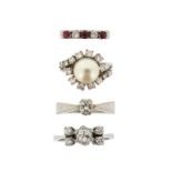 Four gem-set white gold rings, including a diamond solitaire, a diamond five stone ring, a ruby