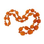 A single-row amber bead necklace, the beads graduate from 17mm to 30mm, 112cm, 243.9g total