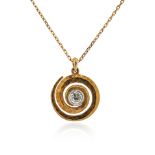 A diamond set gold pendant, the hammered gold swirl centred with an old circular-cut diamond