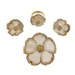 A rock crystal and diamond brooch pendant, the carved rock crystal petals set within a surround of
