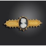 An Etruscan Revival gold brooch, set with a hardstone cameo depicting