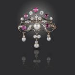 A Victorian ruby, pearl and diamond brooch, of scrolling form, suspending three articulated pearl