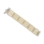 A diamond and cultured pearl bracelet, formed as four rows of cultured pearls measuring