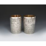 A pair of Gerald Benney silver gilt beakers, slightly swollen cylindrical form with textured