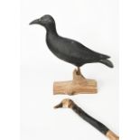 A Thomas Langan Roslyn Harbor carved wood decoy, painted in colours, on tree trunk stand, and a