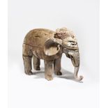 A carved wood Indian Elephant, with carved headdress and saddle, painted decoration, 80cm. high,