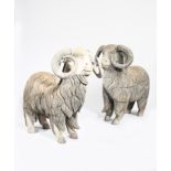A large pair of carved wood sheep, with painted detailing, 122cm. wide, 111cm. high (18) Provenance: