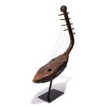 A Zande harp Democratic Republic of the Congo wood, hide and fibre with a carved head finial and