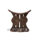 A Shona headrest Zimbabwe with pierced and carved supports, 14.2cm high. Provenance Private