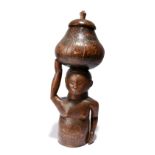 A South African female half figure supporting a lidded container on her head, with pokerwork