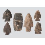 Five Neolithic flint arrowheads the longest, 7.5cm and a stone with a drilled hole. (6) Provenance