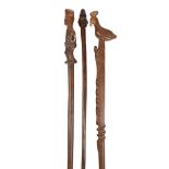 Three South African staffs including two Zulu, one with a carved standing colonial figure finial,