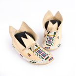 A pair of Cheyenne woman's moccasins Plains buckskin, rawhide and coloured glass beads with
