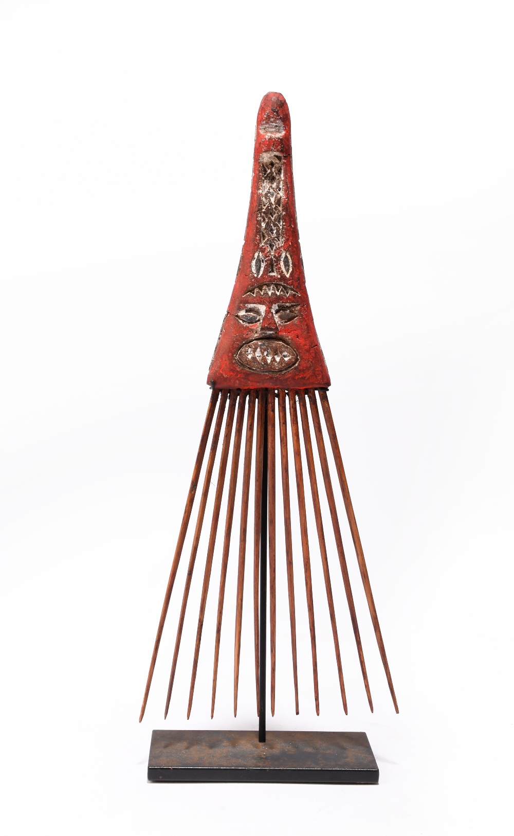 An Admiralty Islands comb Melanesia with a carved wood handle, with putty and with red and white