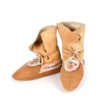 A pair of Athapaskan child's moccasins Subarctic smoked buckskin, caribou, coloured cotton thread