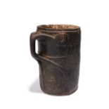 A Tibet milk pot with three carved bands of interlaced designs and with a zoomorphic handle, 21cm