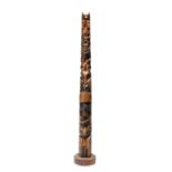 A model totem pole from Ye Olde Curiosity Shop, Seattle cedar with animals and a seated figure, with
