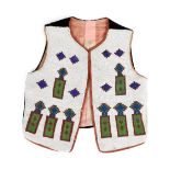 A Plains vest probably Assiniboine or Cree canvas, cloth, velveteen and coloured glass and cut steel