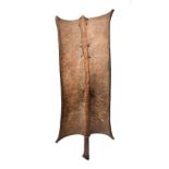 A Turkana shield Kenya hide with a bound wood rib and handle, 58.5cm long.