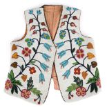 A Cree or Saulteaux vest Canada canvas, cloth and coloured glass beads, with trailing floral designs