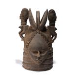 A Mende helmet mask Sierra Leone with a ringed neck and a detailed coiffure including carved