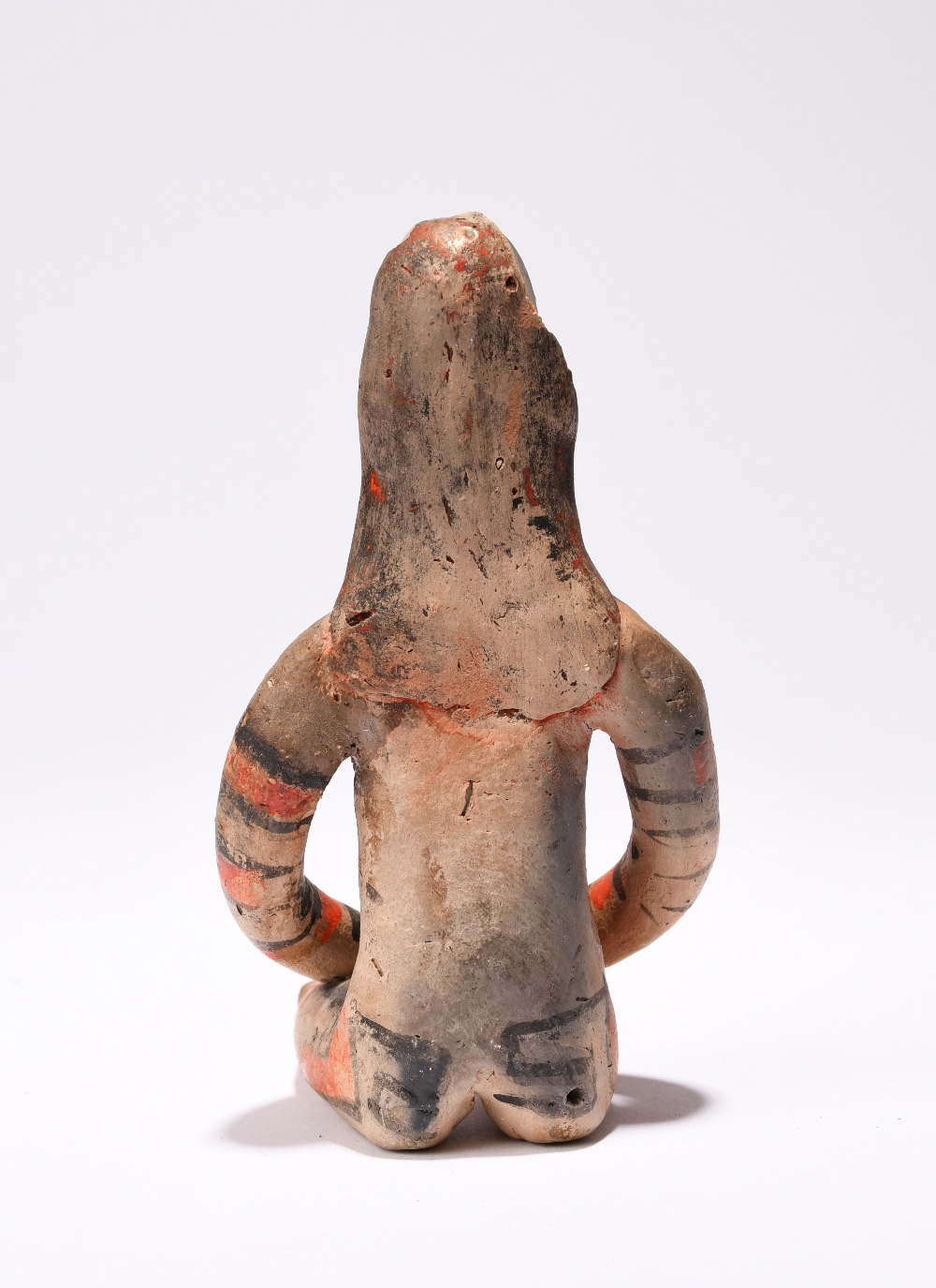 An Amazonian seated female figure Brazil earthenware with red and black decoration, 12cm high. - Image 2 of 3