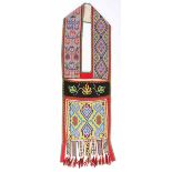 An Ojibwa bandolier bag Northeast North America trade cloth and coloured glass beads, of geometric