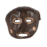 A Mbole mask Democratic Republic of the Congo leather with fibre and cloth, with white pigment