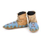 A pair of Plains child's or woman's moccasins possibly Assiniboine buckskin and coloured glass beads