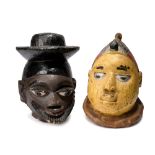 Two Yoruba masks Nigeria gelede and egungun, with painted decoration, 23cm and 23.5cm high. (2)