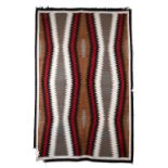 A Navajo rug Southwest North America with wavy diamond bands, 197cm x 128cm.